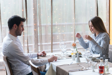 food, christmas, holidays and people concept - smiling couple eating main course at restaurant
