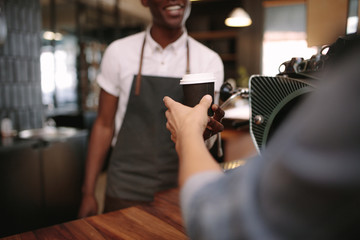 Barista serving customers inside a coffee shop