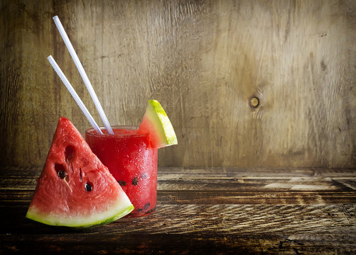 Fresh water melon smoothie on a wooden background, rural style, selective focus
