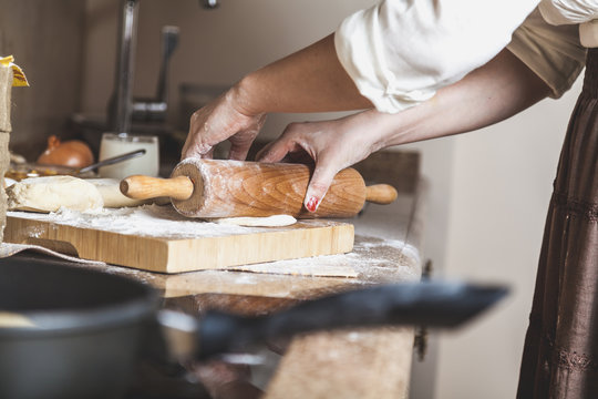 Female hand rolled dough with rolling pin