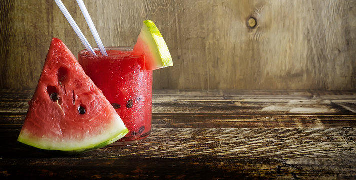 Fresh water melon smoothie on a wooden background, rural style, selective focus