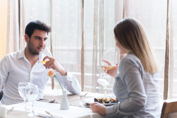 food, christmas, holidays and people concept - smiling couple eating main course at restaurant