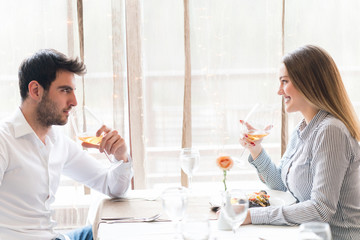 food, christmas, holidays and people concept - smiling couple eating main course at restaurant