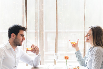 food, christmas, holidays and people concept - smiling couple eating main course at restaurant