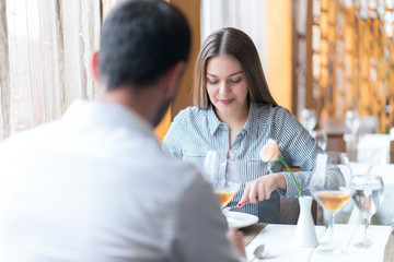 food, christmas, holidays and people concept - smiling couple eating main course at restaurant