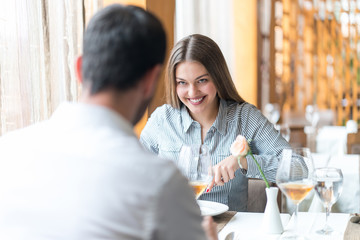 food, christmas, holidays and people concept - smiling couple eating main course at restaurant