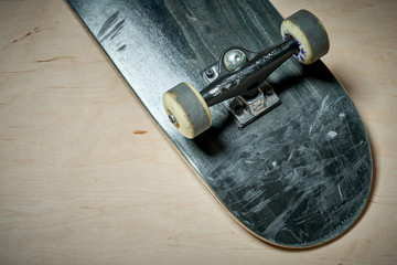 black used skateboard on a light wooden background