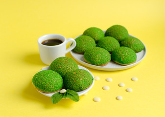 31.	Cakes with mint cream inside decorated with fresh mint and white chocolate on yellow background