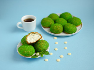 1.	Cakes with mint cream inside decorated with fresh mint and white chocolate on blue background