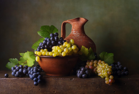 Still life with grapes in the bowl and jug