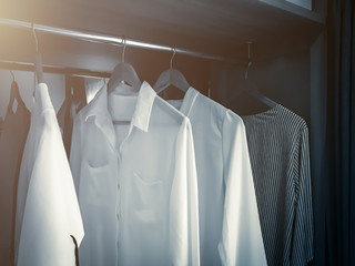 WHITE SOFT CLOTHS HANG IN WARDROBE INTERIOR CONCEPT