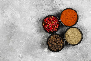 Various pepper on a gray background. Top view, copy space. Food background