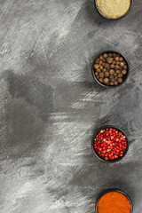Obraz na płótnie Canvas Various pepper on a black background. Top view, copy space. Food background