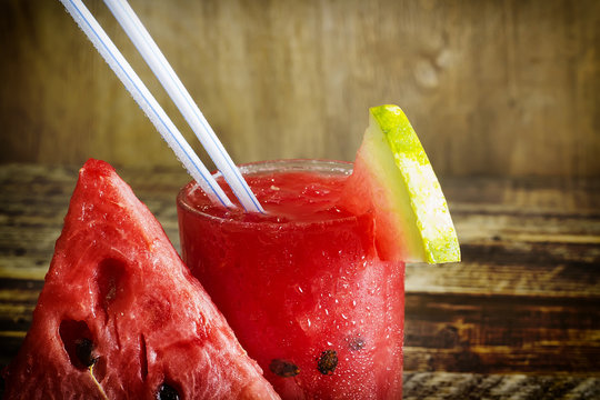 Fresh water melon smoothie on a wooden background, rural style, selective focus
