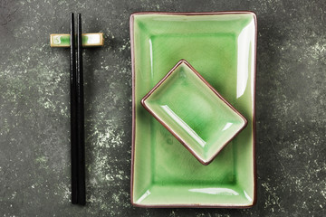 Traditional ware for Asian food on a green background. Top view. Food background