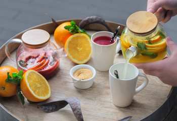 orange tea with ginger and raspberries on a wooden background