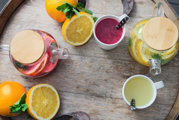 orange tea with ginger and raspberries on a wooden background