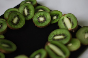 Green kiwi fruit on a black background