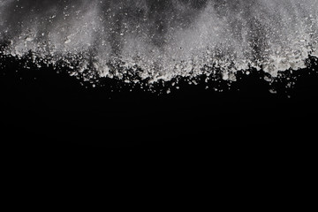 White powder on black background.
