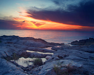 sunset over ocean rocks