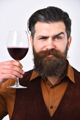 Friendly caucasian man with short black hair holding wine glass