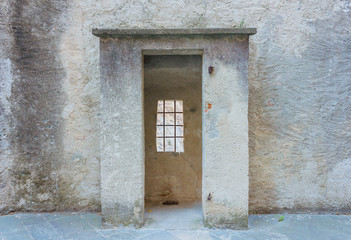 the sentinel room with the window with security grating of an ancient castle / detail of a the...