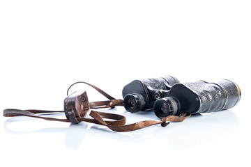 Old vintage binoculars on white background, reflections and shadows, Soviet binoculars WWII