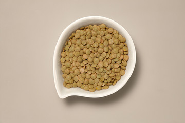 Whole Grains. Top View of Healthy grain foods in a White bowl on grey background with Real Shadow.