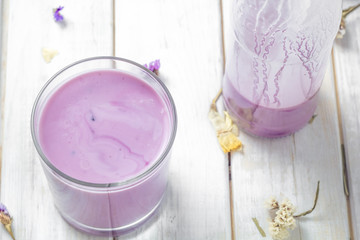 Yogurt in a glass and a bottle on a white background.