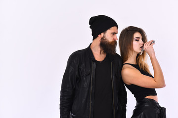 Girl and bearded man in black leather jacket and hat