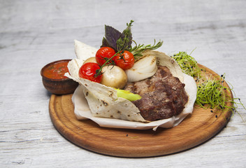 fried meat in pita bread with tomatoes and mushrooms