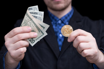young businessman holding dollars and coins of crypto currency bitcoin