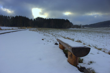 Bench covered in snow