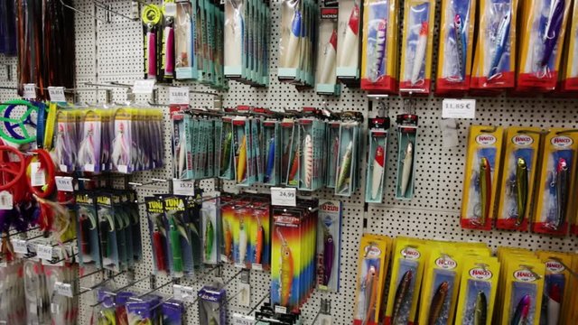 BARCELONA, SPAIN- JANUARY 16, 2018: Variety of assortment on racks in fishing shop in Barcelona