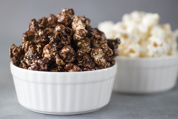 Popcorn in  white bowls on a gray background.