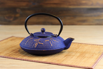 Blue Chinese cast iron teapot. Cooking utensils.