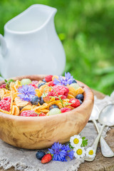Closeup of cornflakes with druits and flowers