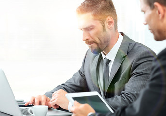 closeup.business colleagues sitting at a Desk.