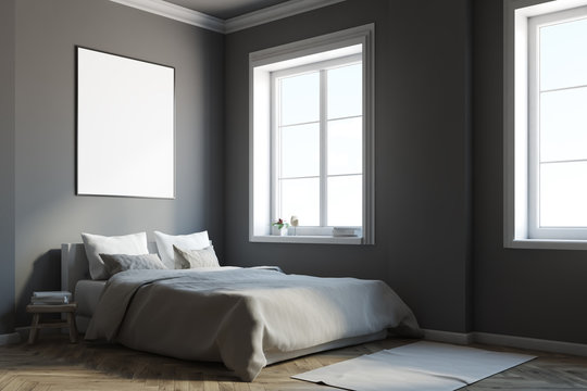 Dark gray bedroom corner with a poster