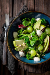 Top view of kale salad with vegetables and avocado