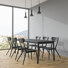 Dark gray dining table in a gray room corner