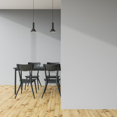 Dark gray dining table in a gray room, wall