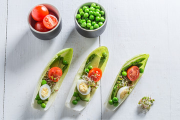 Top view of salad with avocado, asparagus in chicory