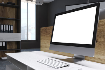 Blank computer screen in a wooden office