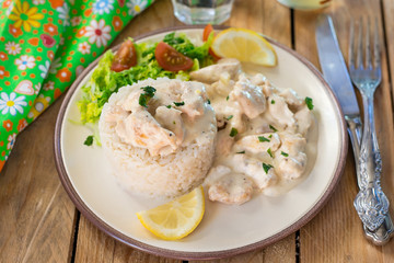 Chicken in cheesy creamy sauce served with rice