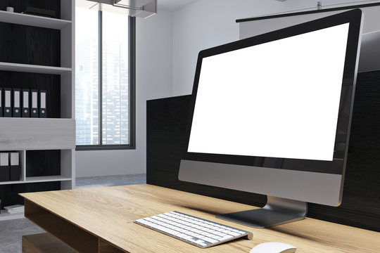 White desktop screen on table in office
