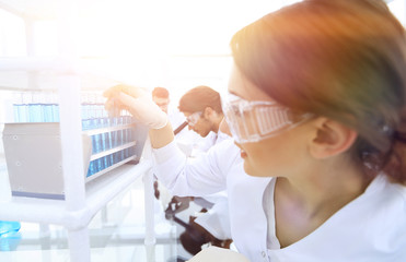 Young woman with test tubes in the laboratory