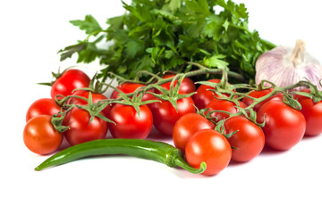 tomatoes, green peppers and other vegetables on a white background.