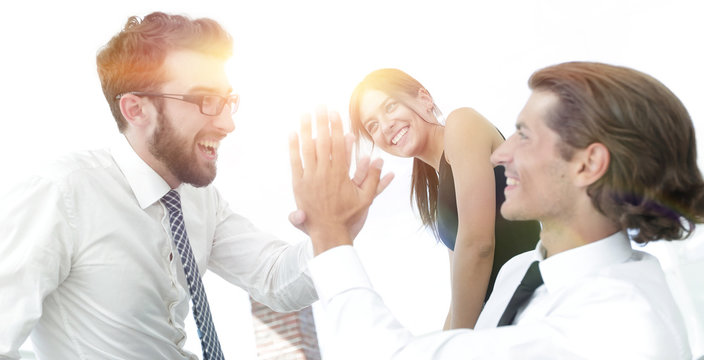 business colleagues giving each other high five.