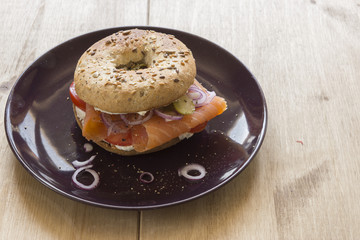 Whole Grain Bagel with salmon, cream cheese, onions and kosher pickle